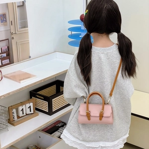 Pink and brown children's crossbody bag with elegant leather texture and shoulder strap