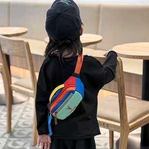 Colorful patchwork kids waist bag with deer logo and adjustable strap on a young model