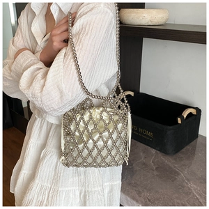 Detail of silver beaded handbag featuring a satin drawstring pouch and mesh weave