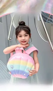 Detail of shell-shaped rainbow backpack for kids with colorful glitter stars and pink strap