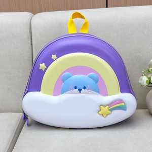 Detail view of the rainbow-colored hardshell kids backpack featuring a cute 3D bear and clouds