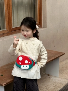 Detail of red mushroom waist bag for kids with adjustable green strap on small model
