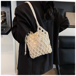 Detail of beaded pearls handbag with satin drawstring lining and double pearl strap