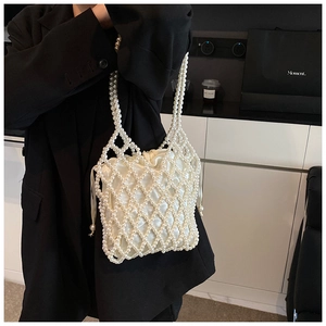 Detailed view of woven pearl shoulder bag with a white satin drawstring inner pouch