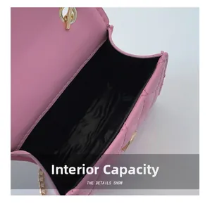 Detail showing internal capacity and black lining of pink quilted chain bag