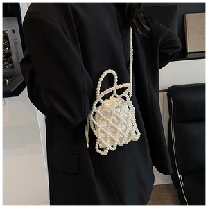 Detail of beaded pearl handbag with satin drawstring liner and woven strap