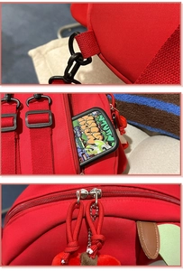 Detail des roten Rucksacks mit D-Ringen und Doppelreißverschlüssen mit Kordelzuglaschen