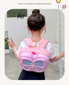 Detailed back view of pink butterfly shell backpack with 3D wings and plush zipper pulls