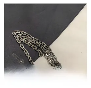 Detailed macro view of the glossy silver metal chain link and hardware on the child bag