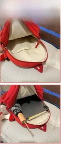 Innenansicht des roten Apfel-Rucksacks mit iPad, Regenschirm und Büchern darin