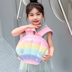 Front view of shell-shaped kids backpack with rainbow gradient and star details