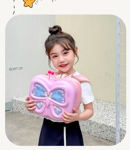Detail of pink 3D butterfly hardshell kids backpack with colorful wing textures
