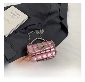 Close-up of metallic pink quilted mini bag with silver chain and beaded handle