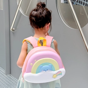 Pink eggshell toddler backpack featuring rainbow clouds and blue bear on a cute schoolbag