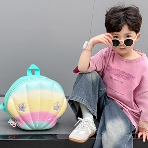 Kid modeling a gradient shell-shaped backpack with glitter stars and macaron colors