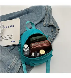 Detailed view of the open teal nylon mini bag interior showing ample storage space