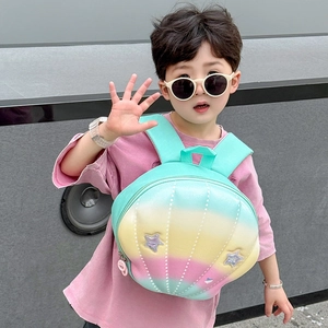 Outdoor shot of stylish rainbow shell backpack with star patterns for kids