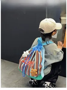 Kids' colorful striped drawstring backpack with cute plush bear charms on back of child