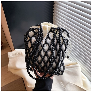 Detailed shot of black beaded mesh bag featuring a white satin drawstring interior liner