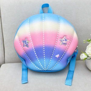 Close-up of shell-shaped kids backpack with rainbow gradient and laser star detail
