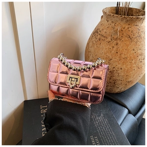 Detailed macro view of pink quilted patent leather mini bag with silver bead handle
