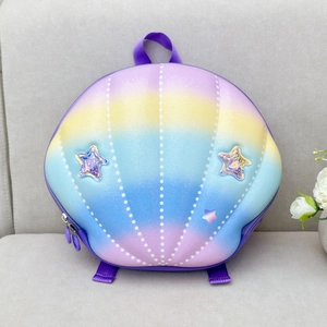Detailed macro view of seashell shaped rainbow backpack with iridescent star patches and dots