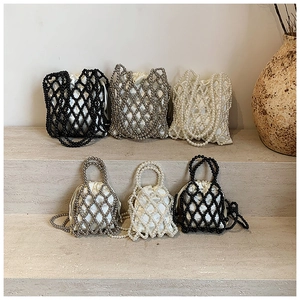 Artistic display of handmade beaded handbags with drawstring satin liners in multiple colors