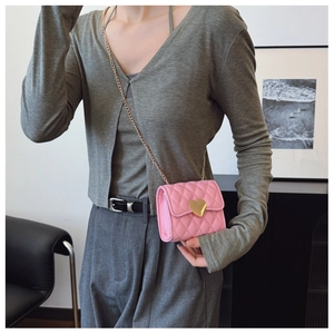 Pink quilted crossbody bag for girls with gold heart clasp and metal chain detail
