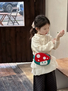 Detail view of a cute cartoon mushroom crossbody bag for kids with durable canvas texture
