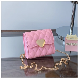 Detailed view of pink quilted mini crossbody bag with golden heart-shaped metal buckle