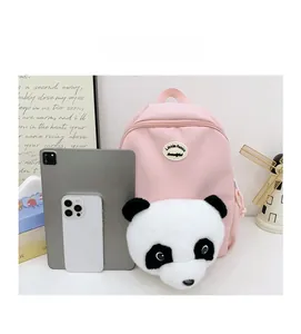Pink panda backpack shown next to a tablet and phone for real-size comparison