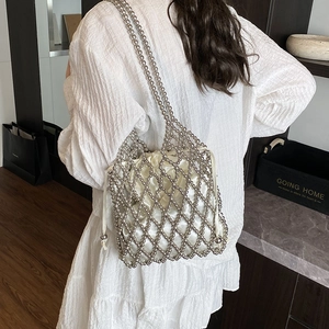 Fashionable silver beaded shoulder bag with satin drawstring liner shown on model