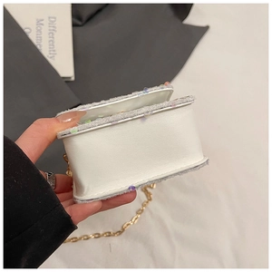 Detail view showing the bottom thickness and colorful sequin trim of the mini chain bag