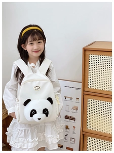 Detail of cute 3D panda plush decoration on white canvas backpack for children