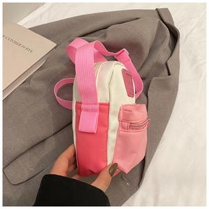 Detail of mini canvas shoulder bag for kids with pink stitching and adjustable strap