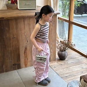 Silver quilted metallic chain bag for kids paired with pink cargo pants and striped vest