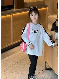 Detail view of children's white long sleeve shirt with black side stripes and ERA logo
