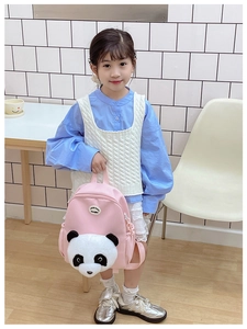 Detail of pink kids backpack with 3D plush panda design and side storage pockets