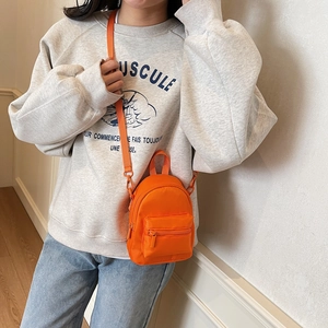 Vibrant orange mini nylon crossbody bag for women with adjustable strap and front pocket