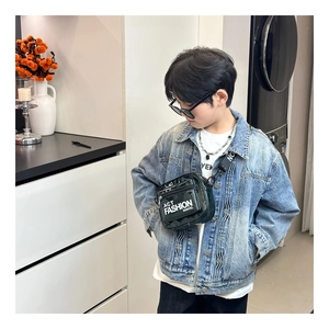Detail of kids black patent leather crossbody bag with wide strap and letter print