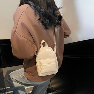 Minimalist creamy white mini nylon shoulder bag with zipper pocket and adjustable straps
