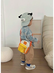 Kid's mini crossbody bag in vibrant orange and white colors for stylish outdoor outfits