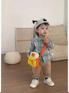 Kids orange canvas crossbody bag shown with a stylish autumn plaid outfit