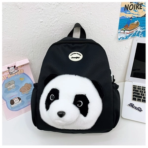 Detail of cute panda face plush on black school backpack with elastic side pocket