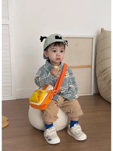Kids orange and yellow canvas crossbody bag styled with a plaid shirt and casual trousers