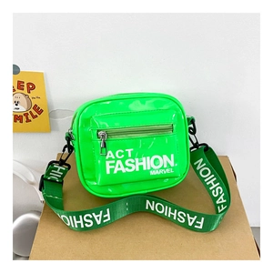 Macro shot of a neon green glossy crossbody bag featuring wide lettered straps and zipper pockets