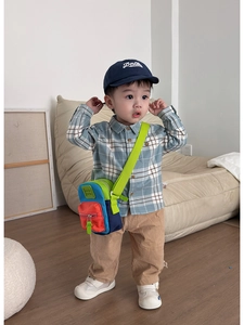 Toddler mini crossbody bag with colorful stitching and adjustable green shoulder strap