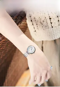 Elegant ladies quartz watch with silver steel band and Roman numeral dial on wrist