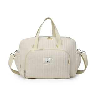 Sac à langer matelassé beige avec motifs floraux jaunes et bandoulière réglable