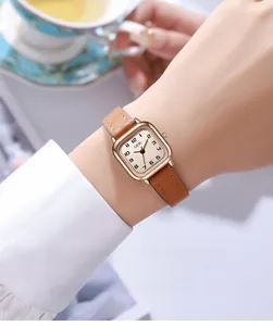 Macro view of a GEDI vintage square watch featuring a brown leather strap and rose gold case